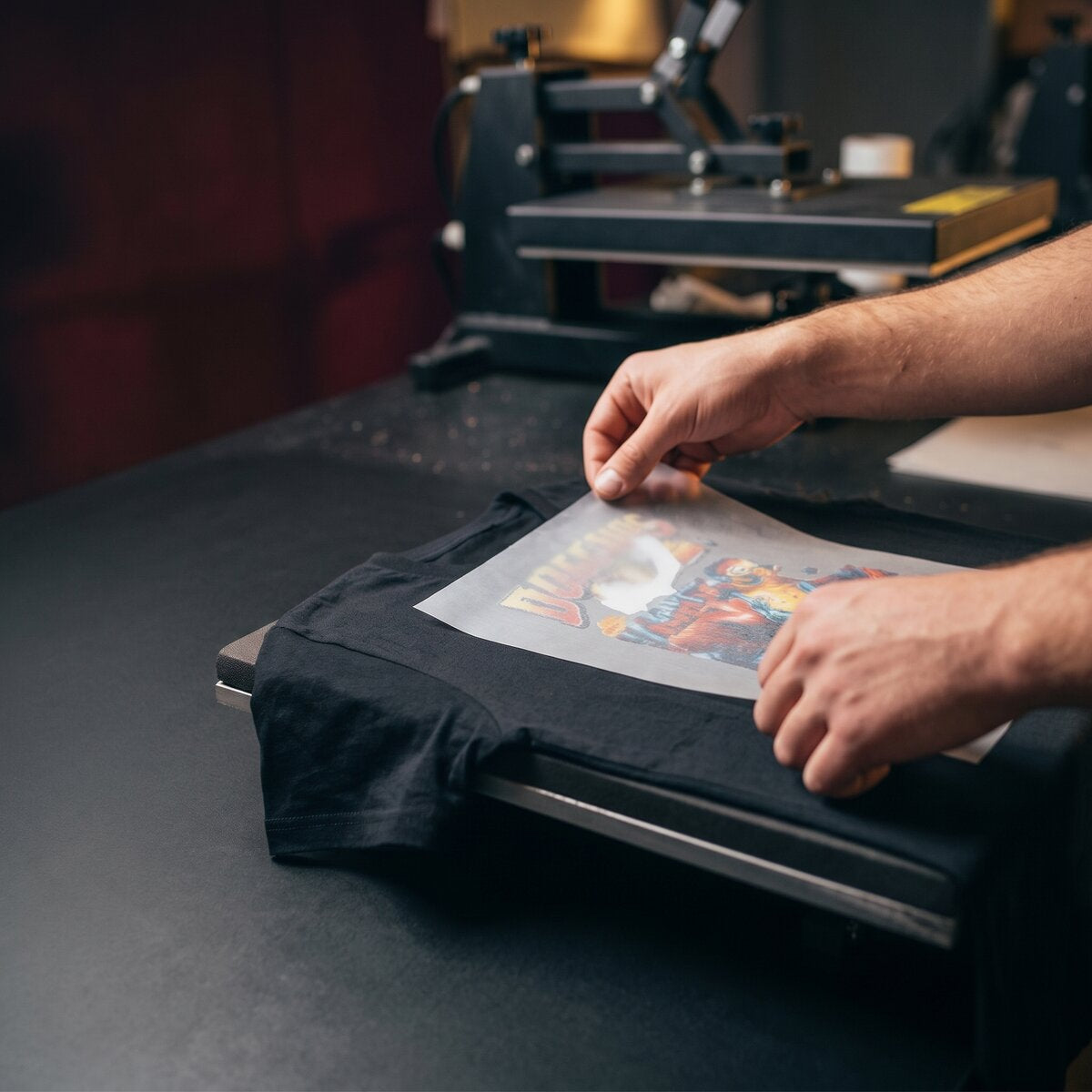 Step 1: positioning a DTF transfer on the chest of a t-shirt on the heat press